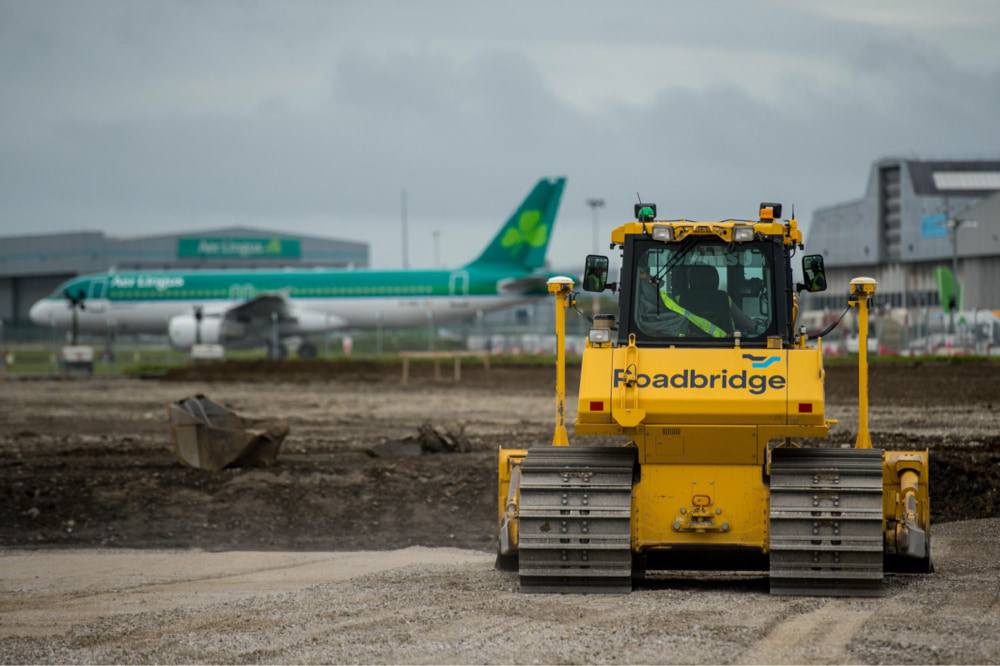 Photograph of a Roadbridge bulldozer in front of an airport jobsite
